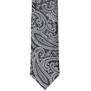 The front tip view of a black paisley slim tie