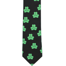 Load image into Gallery viewer, The front of a black slim tie with green shamrocks scattered