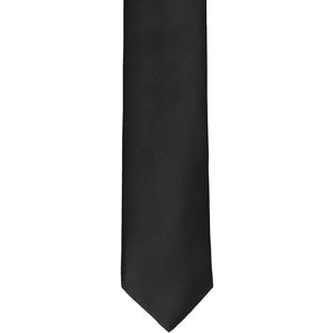 The front of a black skinny tie, laid out flat