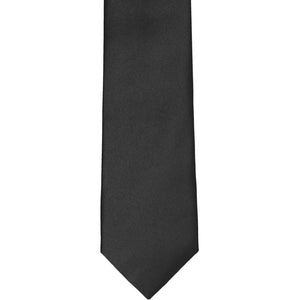 The front of a black slim tie, laid out flat