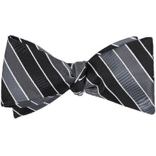 Load image into Gallery viewer, A black striped self-tie bow tie, tied