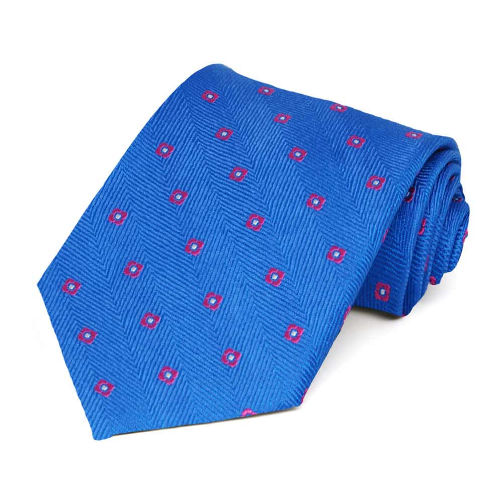 A rolled bright blue tie with small red square shaped flowers