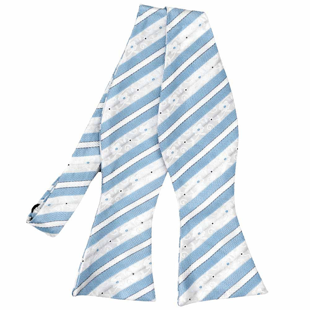 An untied self-tie bow tie in a blue and white floral stripe pattern
