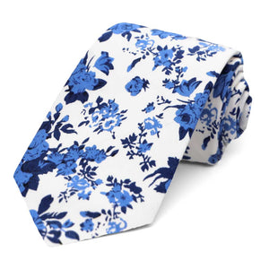 A blue and white floral tie, rolled to show off the pattern