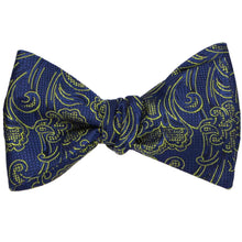 Load image into Gallery viewer, A tied blue and yellow floral bow tie with a textured, checkered pattern