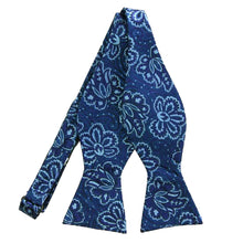 Load image into Gallery viewer, An untied blue self-tie bow tie with large lighter blue flowers