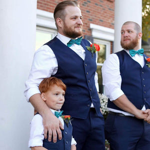 Groom, groomsman and ring bearer wearing matching oasis bow ties