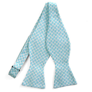 An untied white and light blue self-tie bow tie with an oval pattern