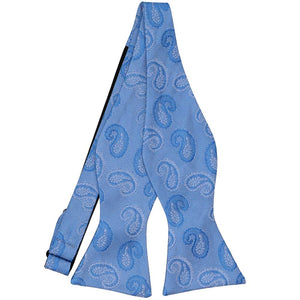 A blue tone-on-tone self tie bow tie, untied, with a paisley pattern