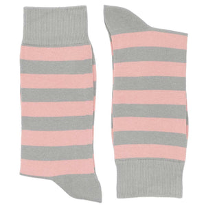 A pair of blush pink and gray striped socks, folded