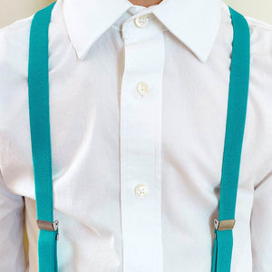 Boy wearing a white dress shirt and cyan blue suspenders