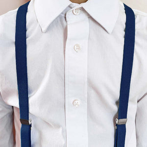 Boy wearing dark blue suspenders with a white dress shirt