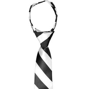 The collar and knot on a boys black and white pre-tied zipper tie