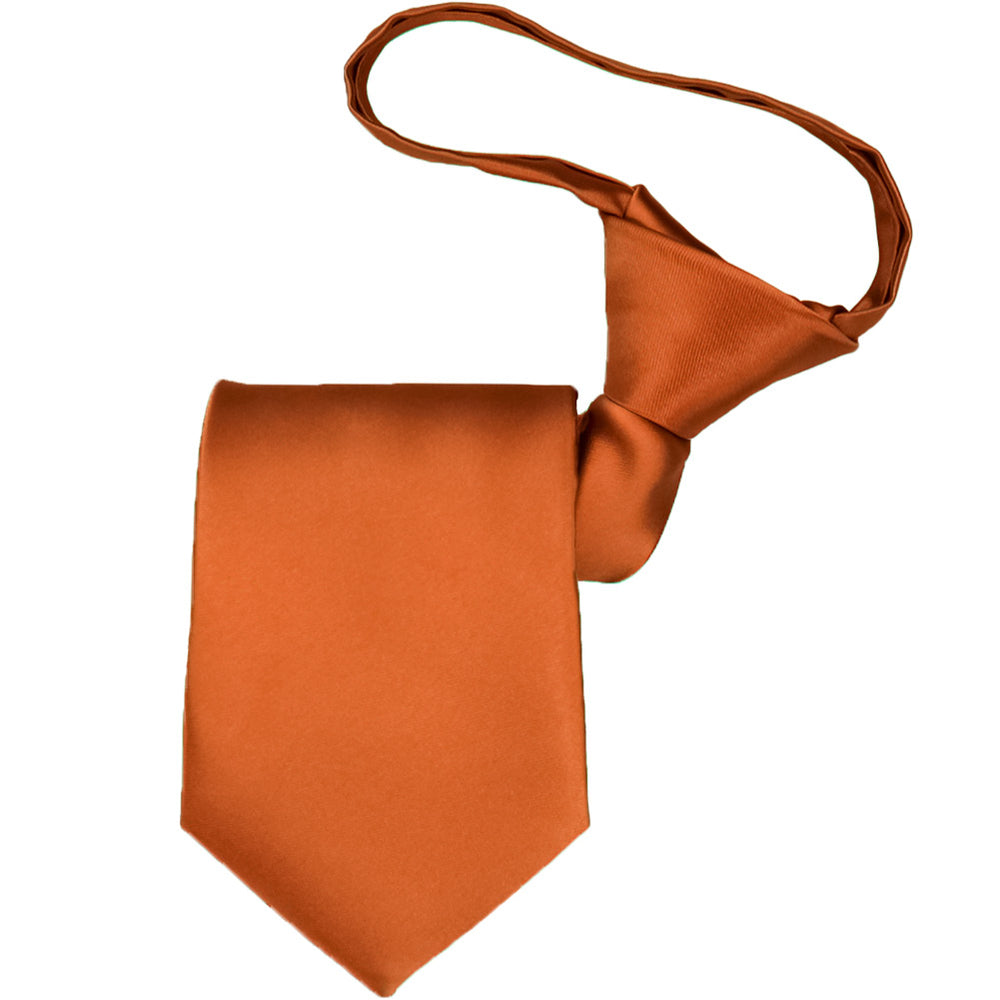 A boys' pre-tied burnt orange tie, folded to display the knot and tie tip