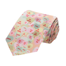 Load image into Gallery viewer, A boys peach necktie with a candy hearts all over design, rolled to show off the pattern