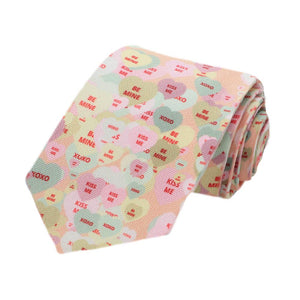 A boys peach necktie with a candy hearts all over design, rolled to show off the pattern