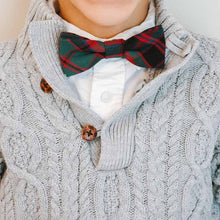 Load image into Gallery viewer, A boy wearing a red and green plaid bow tie under a gray sweater