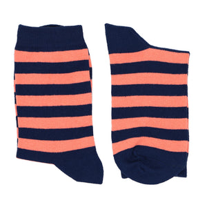A pair of boys coral and navy blue striped socks, folded and laying flat