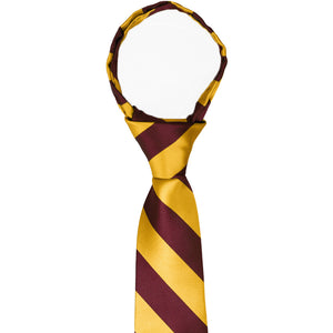 Knot and collar on a boys' maroon and golden yellow striped zipper tie
