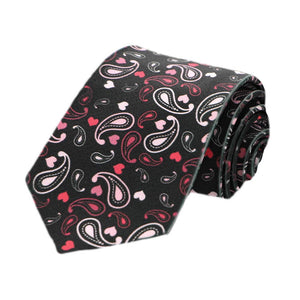 A boys black tie with a pink and red paisley pattern, rolled to show off the design