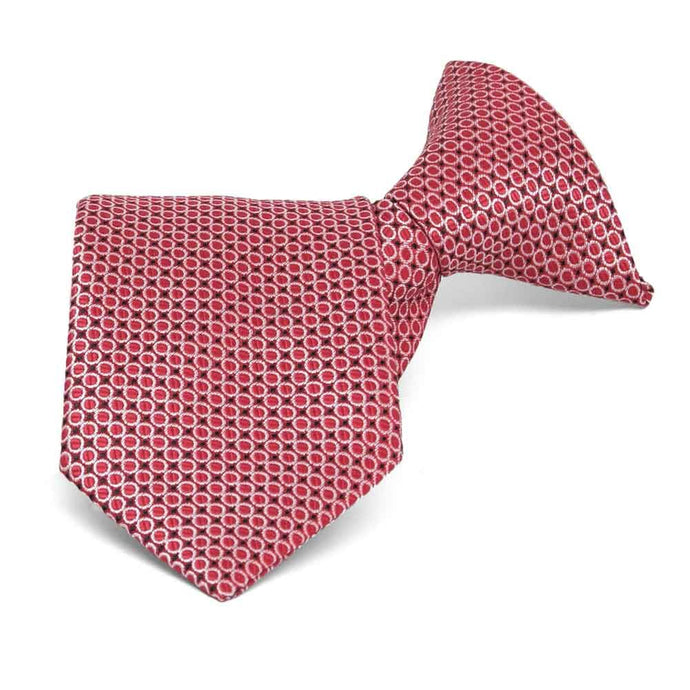 Red circle pattern boys' necktie, rolled to show texture