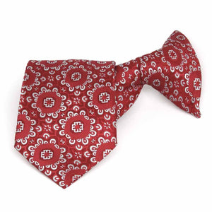 Folded front view of a red and white floral pattern clip-on style boys' tie