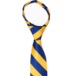 The knot and collar on a boys royal blue and golden yellow zipper tie
