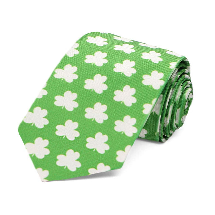 A boys' green and white shamrock tie, rolled to show off pattern
