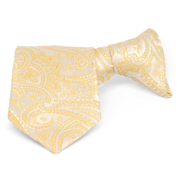 Boys' light yellow paisley clip-on tie, folded front view