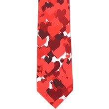 Load image into Gallery viewer, The front flat view of a boys tie with a red scattered heart pattern