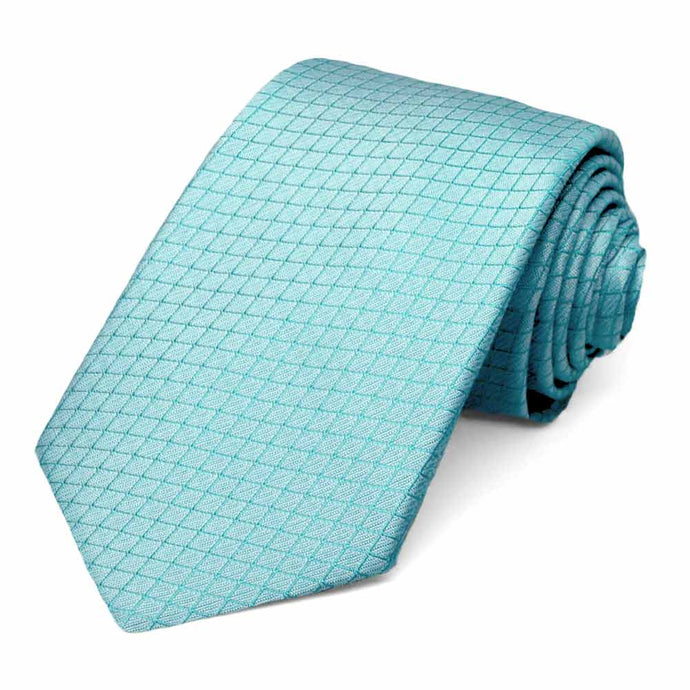 A bright blue lattice patterned necktie, rolled to show the subtle texture
