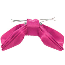Load image into Gallery viewer, The side of a bright fuchsia clip on bow tie, opened 