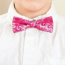Load image into Gallery viewer, A boy wearing a bright fuchsia paisley bow tie with a white dress shirt