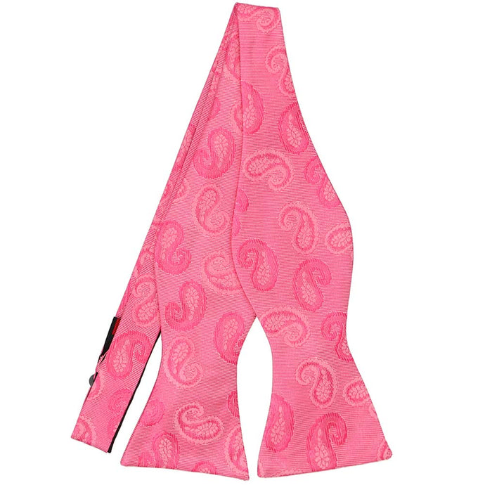 An untied pink self-tie bow tie in a tone-on-tone paisley pattern