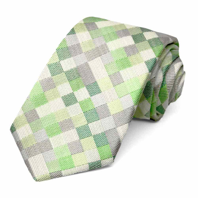 Green and gray checkered tie, rolled to show the woven texture