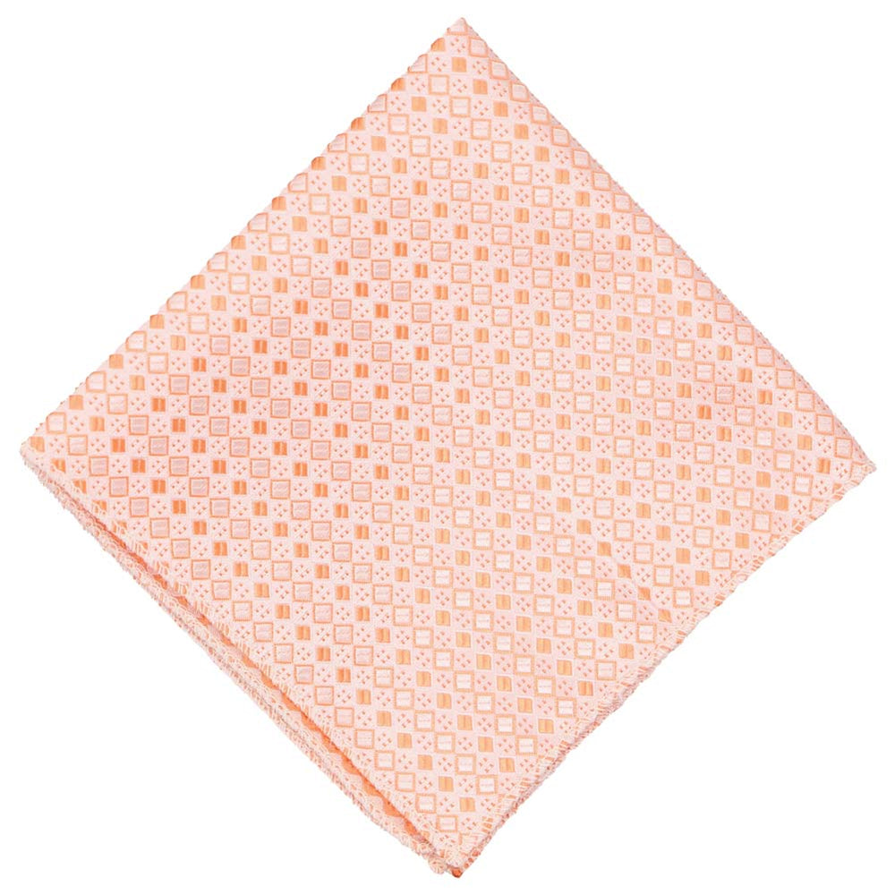 A light orange pocket square with a square pattern, folded to a diamond