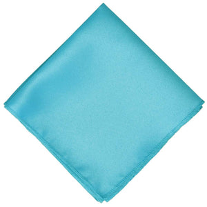 Bright turquoise solid pocket square folded into a diamond