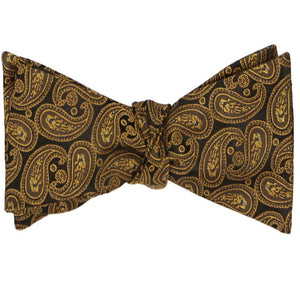 A tied self-tie bow tie in a brown paisley pattern