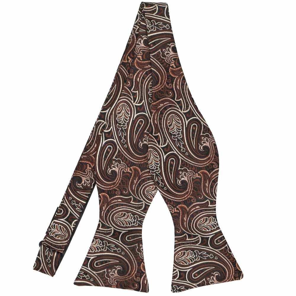 An untied brown self-tie bow tie in a detailed paisley pattern