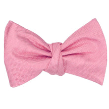 Load image into Gallery viewer, A tied self tie bow tie in a bubblegum pink herringbone pattern