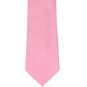The front of a bubblegum pink herringbone patterned tie, laid out flat