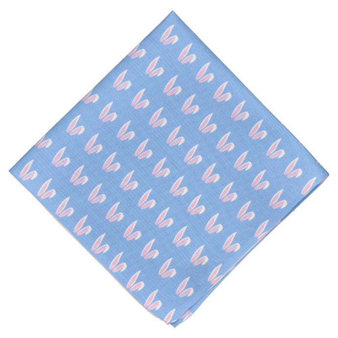 A light blue pocket square folded into a diamond with an all over bunny ears pattern