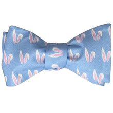 Load image into Gallery viewer, A self-tie bow tie, tied, with an all over bunny ears pattern on a blue background