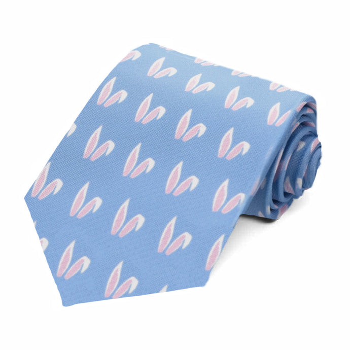 A rolled blue novelty tie with a white and pink bunny ears pattern