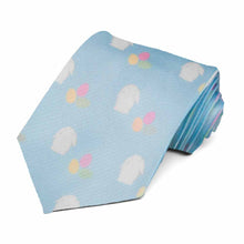 Load image into Gallery viewer, A rolled blue novelty tie with a white bunny and pastel egg pattern repeated across the tie
