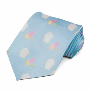A rolled blue novelty tie with a white bunny and pastel egg pattern repeated across the tie
