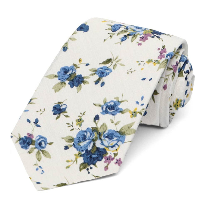 A dusty blue and white floral tie, rolled to show the front