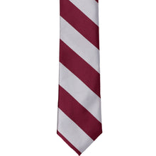 Load image into Gallery viewer, The front of a burgundy and silver striped skinny tie, laid out flat