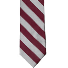 Load image into Gallery viewer, The front of a burgundy and silver striped tie, laid out flat