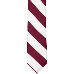 The front of a burgundy and white striped skinny tie, laid out flat